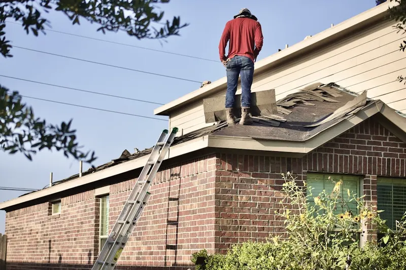Professional roofer working on a residential roof in Travilah